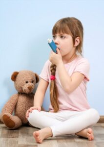 child with asthma using inhaler